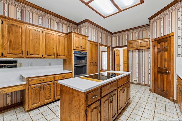 kitchen featuring double oven, black electric stovetop, a kitchen island, and ornamental molding