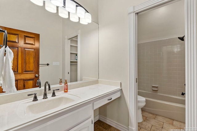 full bathroom featuring vanity, toilet, and tiled shower / bath