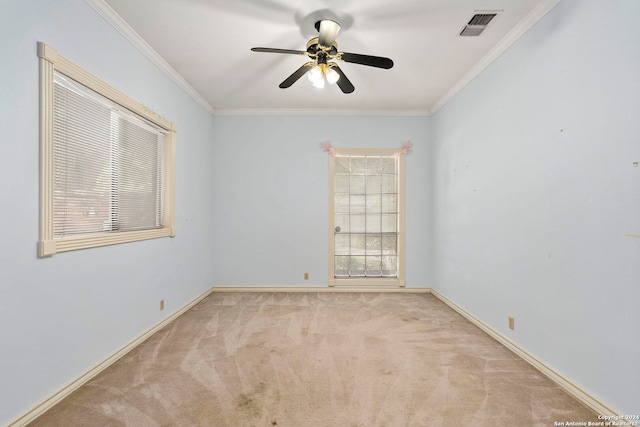 carpeted empty room with ceiling fan and ornamental molding