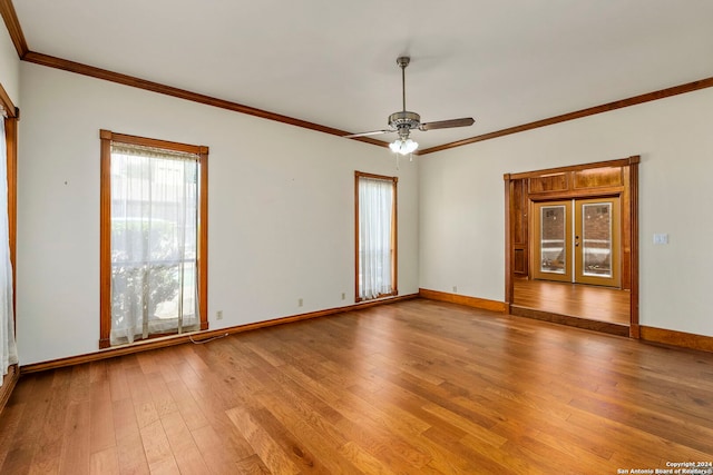 empty room featuring hardwood / wood-style flooring, ceiling fan, and crown molding