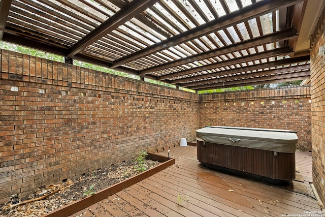 wooden deck with a hot tub