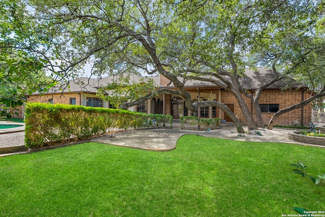 rear view of house featuring a yard