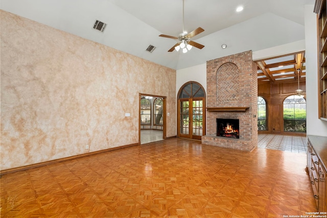 unfurnished living room featuring ceiling fan, high vaulted ceiling, parquet flooring, and a brick fireplace