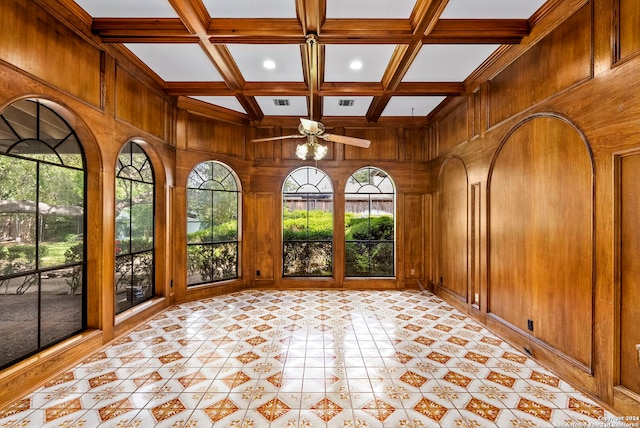 unfurnished sunroom with ceiling fan, beam ceiling, and coffered ceiling