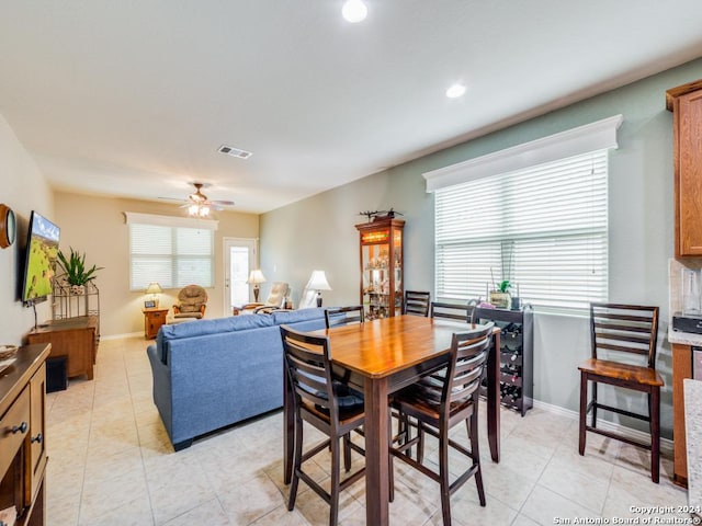 dining space with ceiling fan and light tile patterned flooring