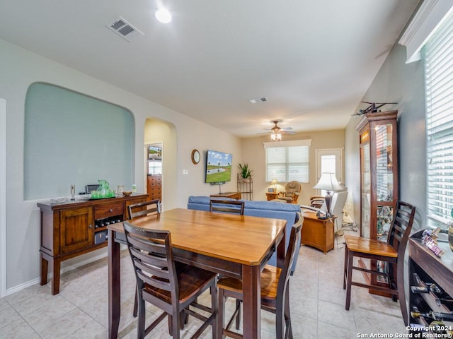 dining space featuring ceiling fan, light tile patterned flooring, and a healthy amount of sunlight