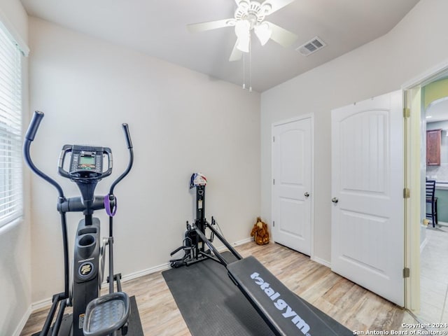 workout area with ceiling fan and light hardwood / wood-style floors