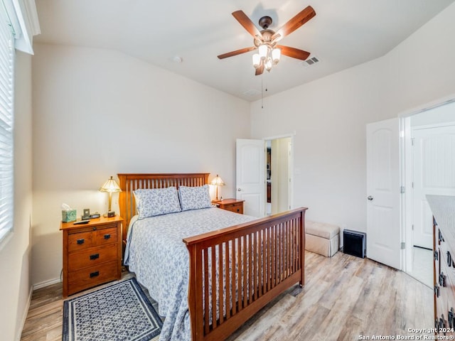 bedroom with ceiling fan, light wood-type flooring, and multiple windows