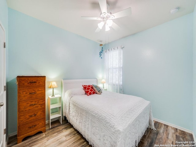 bedroom with hardwood / wood-style flooring and ceiling fan