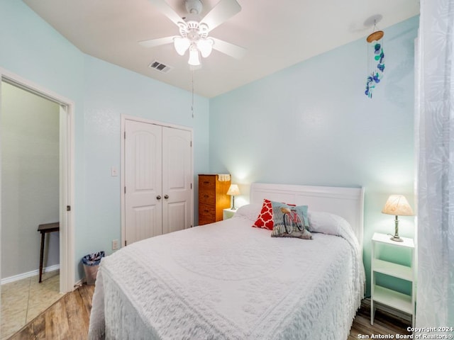 bedroom with a closet, ceiling fan, and hardwood / wood-style flooring