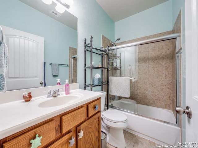 full bathroom featuring tile patterned flooring, vanity, enclosed tub / shower combo, and toilet