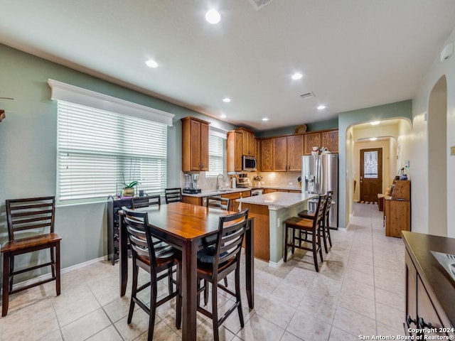 tiled dining space featuring sink