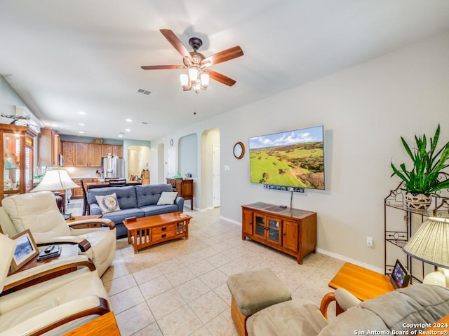 tiled living room featuring ceiling fan