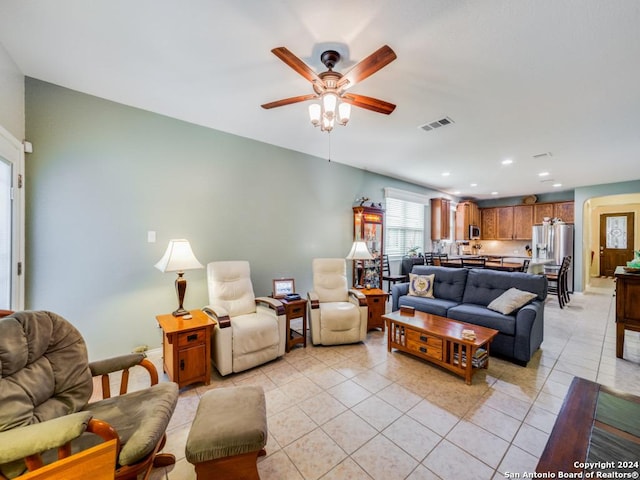 tiled living room with ceiling fan