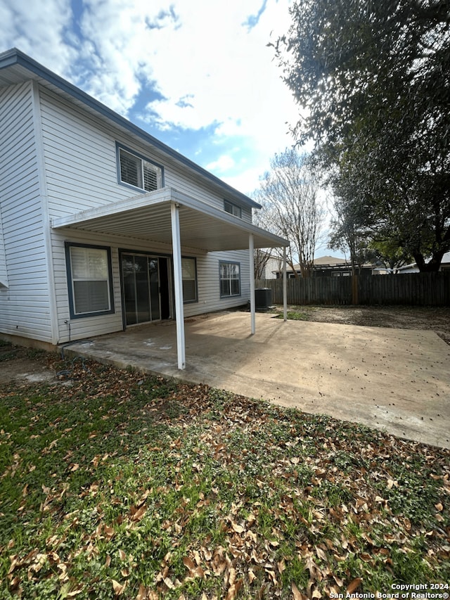 back of property with a patio area and cooling unit