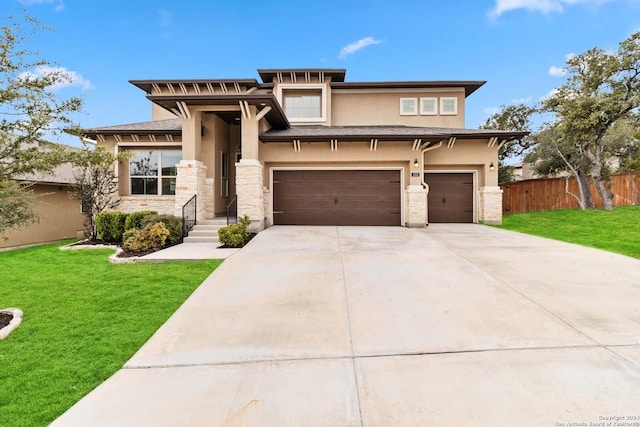 prairie-style house with a garage and a front lawn