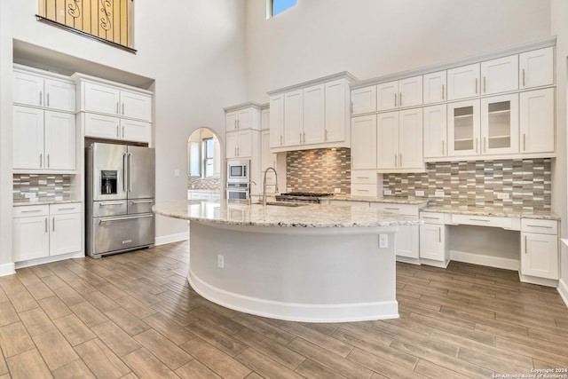 kitchen featuring sink, white cabinets, light hardwood / wood-style floors, and appliances with stainless steel finishes