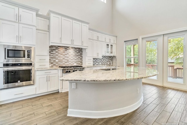 kitchen with white cabinets, plenty of natural light, and appliances with stainless steel finishes