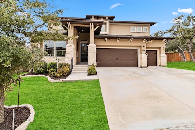 prairie-style home with a garage and a front lawn