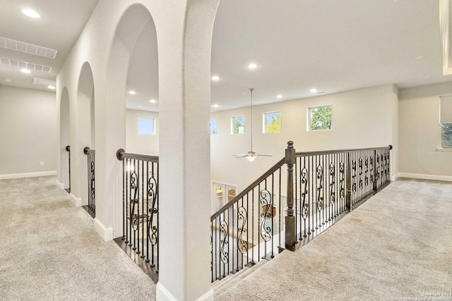 hallway featuring light colored carpet