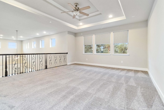 unfurnished room featuring carpet flooring, a wealth of natural light, and ceiling fan