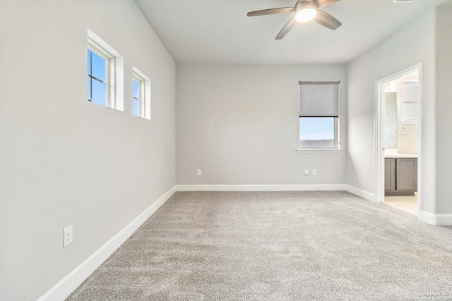 unfurnished room with a wealth of natural light, carpet floors, and ceiling fan