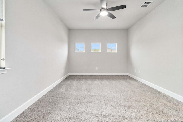 carpeted empty room featuring ceiling fan