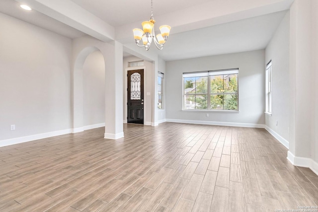 entryway featuring light hardwood / wood-style floors and a chandelier