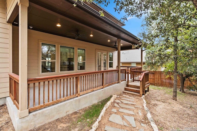 view of side of home featuring ceiling fan and a wooden deck