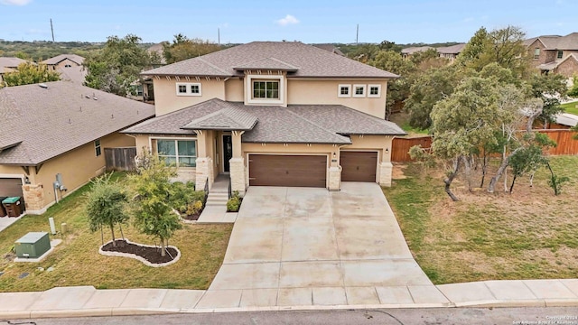 view of front facade with a garage and a front lawn