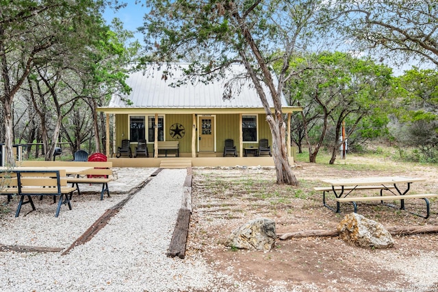 back of house featuring covered porch