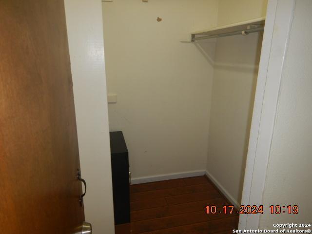 spacious closet featuring dark hardwood / wood-style floors