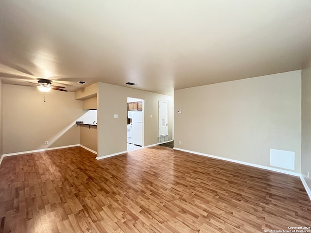 unfurnished living room featuring ceiling fan and wood-type flooring