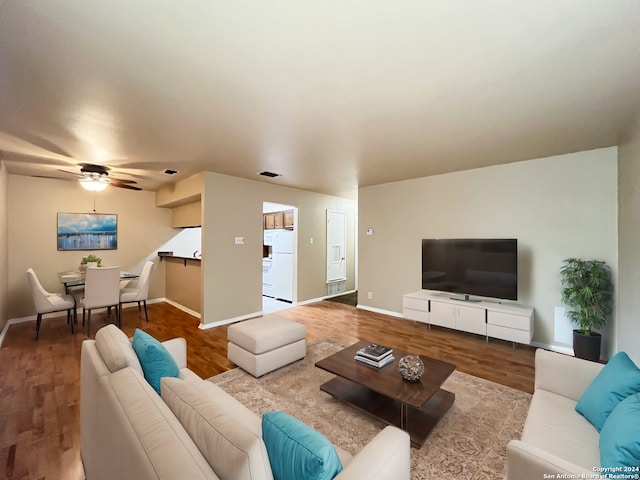 living room featuring ceiling fan and wood-type flooring