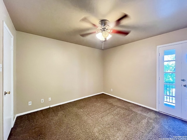 spare room featuring ceiling fan and carpet floors