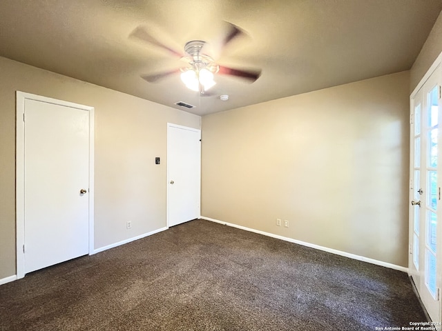 carpeted spare room with ceiling fan