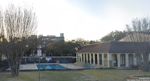 view of swimming pool featuring a yard and a patio