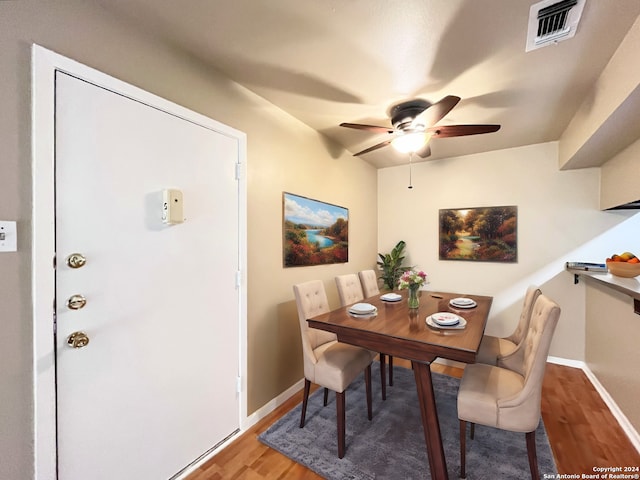 dining area featuring ceiling fan and wood-type flooring