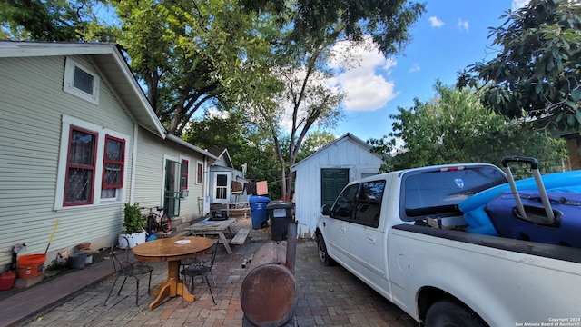 exterior space featuring a storage unit and a patio area