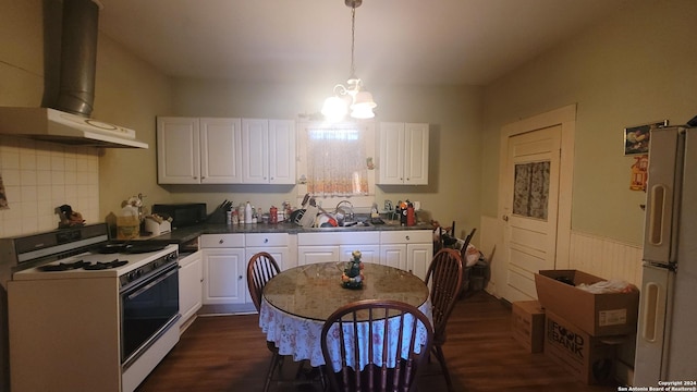 kitchen featuring sink, wall chimney range hood, dark hardwood / wood-style flooring, white appliances, and white cabinets