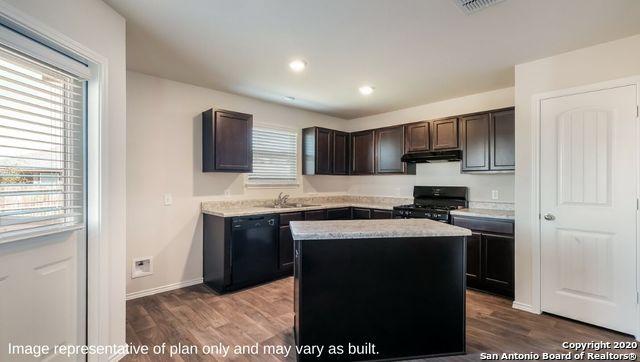 kitchen featuring hardwood / wood-style floors, dark brown cabinetry, a center island, and black appliances