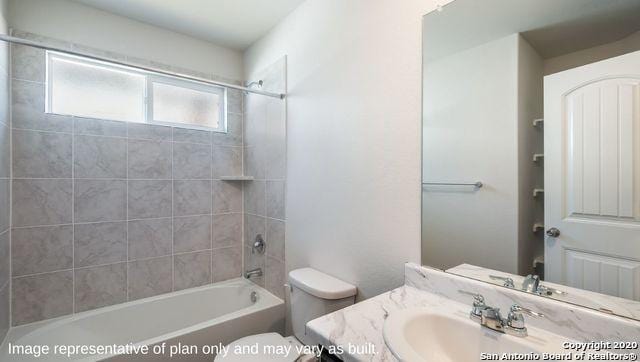 full bathroom with vanity, tiled shower / bath combo, and toilet