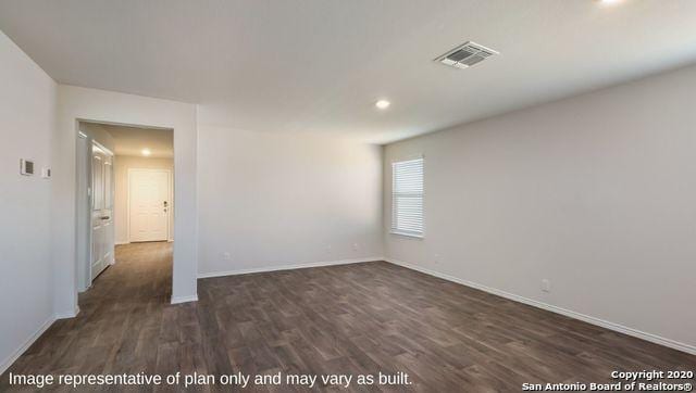 spare room with dark wood-type flooring