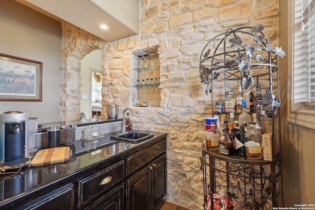 bar featuring wood-type flooring and sink