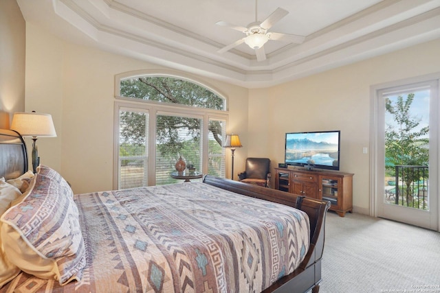 bedroom with access to exterior, a raised ceiling, ceiling fan, and crown molding