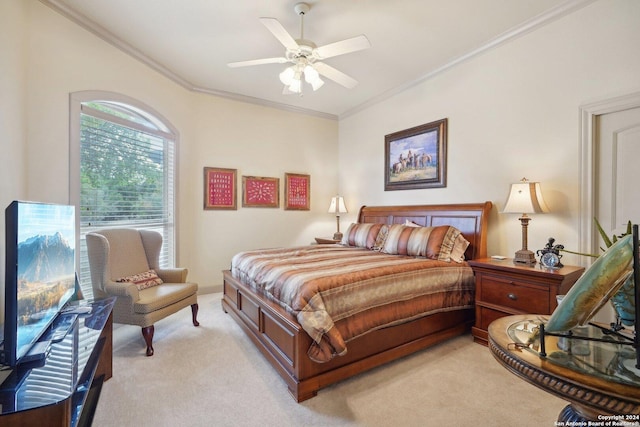 carpeted bedroom featuring ceiling fan and ornamental molding