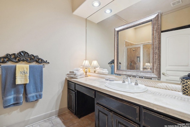 bathroom featuring vanity and a shower with shower door