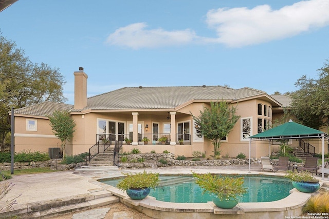 view of pool featuring a patio and central AC unit