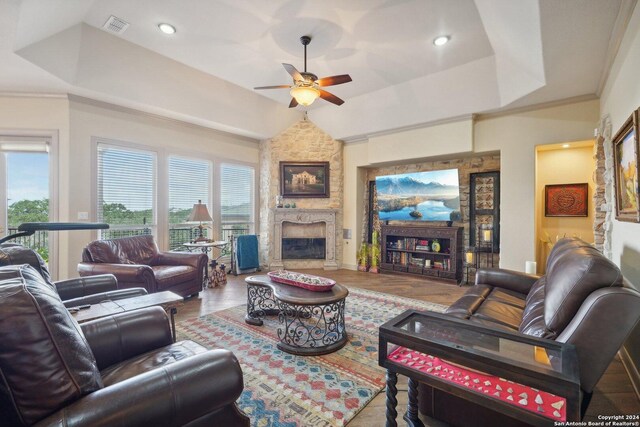 living room featuring plenty of natural light, ceiling fan, wood-type flooring, and a fireplace