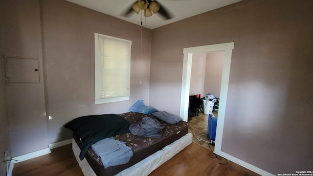 bedroom featuring ceiling fan and dark hardwood / wood-style flooring